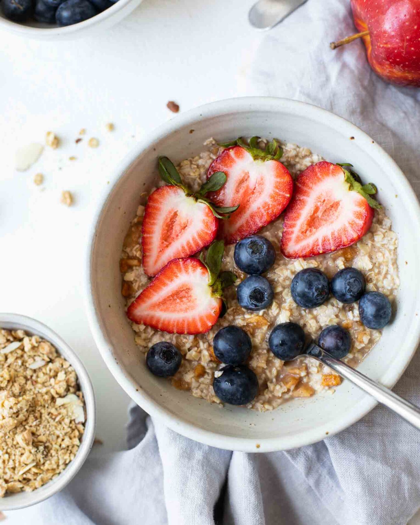 Close up of oatmeal topped with strawberries and blueberries.