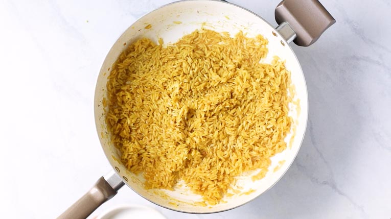 Cooked jasmine rice in a skillet.