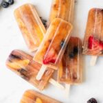 Close up of Lemon Sweet Tea Popsicles with blueberries, strawberries, and peaches.