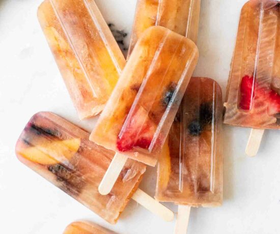 Close up of Lemon Sweet Tea Popsicles with blueberries, strawberries, and peaches.