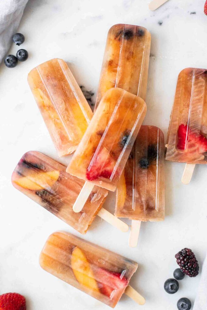 Close up of Lemon Sweet Tea Popsicles with blueberries, strawberries, and peaches.