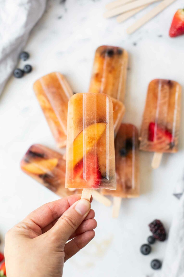 Hand hold close up of sweet tea popsicle.