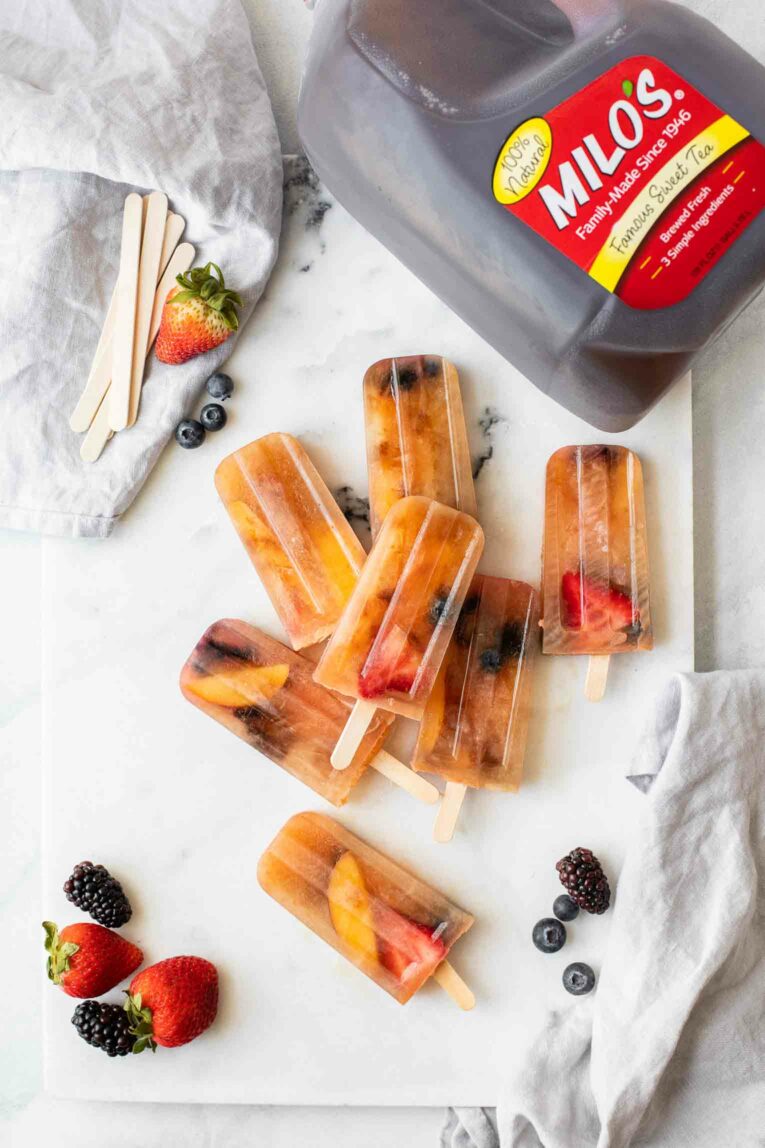 Top shot of Sweet Tea Popsicles next to a jug of Milo's Sweet Tea.