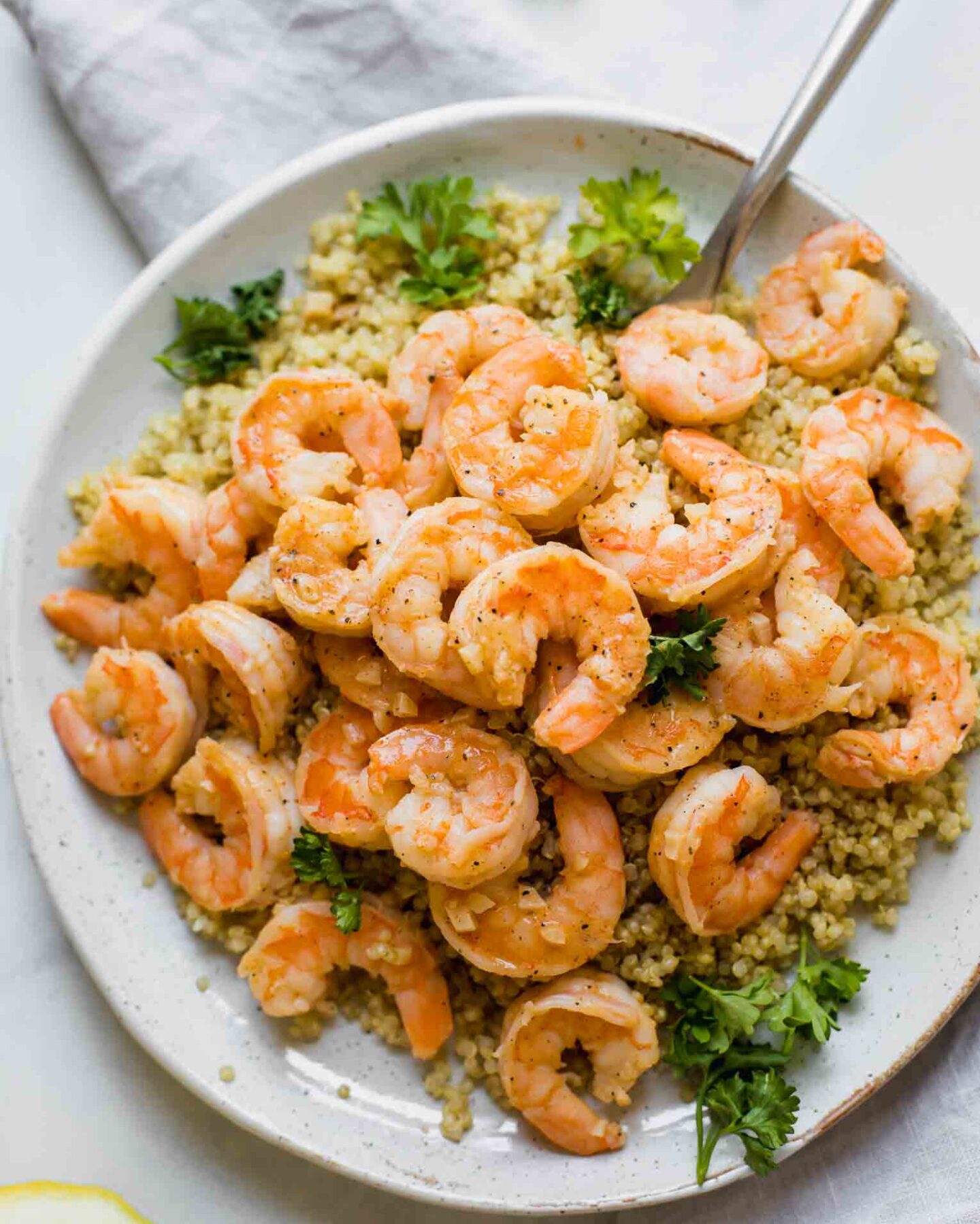 Close up shot of Lemon Garlic Shrimp on a white plate.