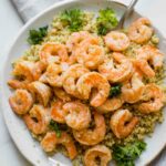 Close up shot of Lemon Garlic Shrimp on a white plate.