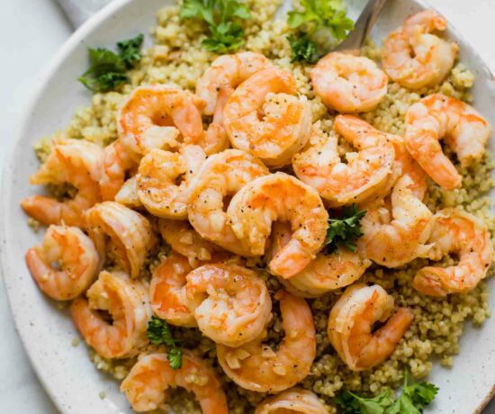 Close up shot of Lemon Garlic Shrimp on a white plate.