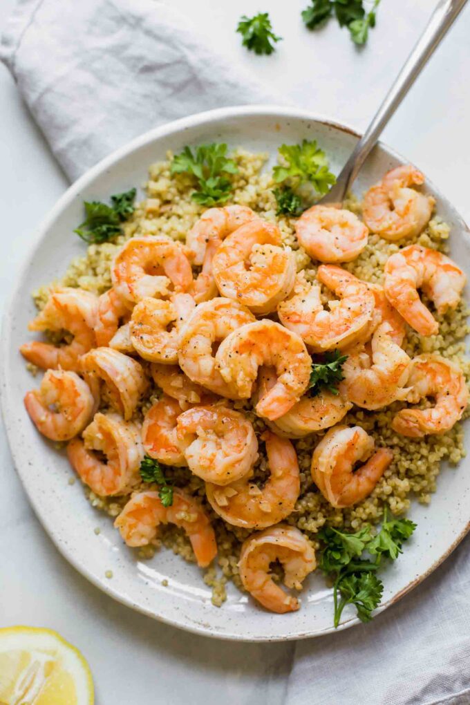 Close up shot of Lemon Garlic Shrimp on a white plate.