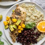 Close up of Cuban Mojo Chicken and Rice on a white plate.
