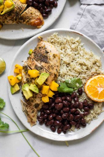 Close up of Cuban Mojo Chicken and Rice on a white plate.