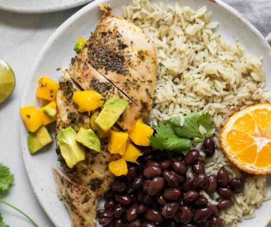 Close up of Cuban Mojo Chicken and Rice on a white plate.