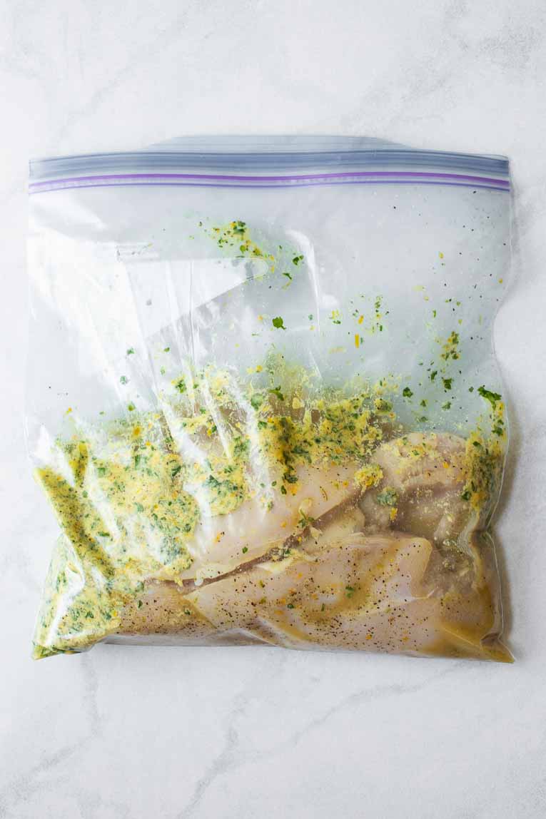 Chicken breasts marinating in a freezer bag.