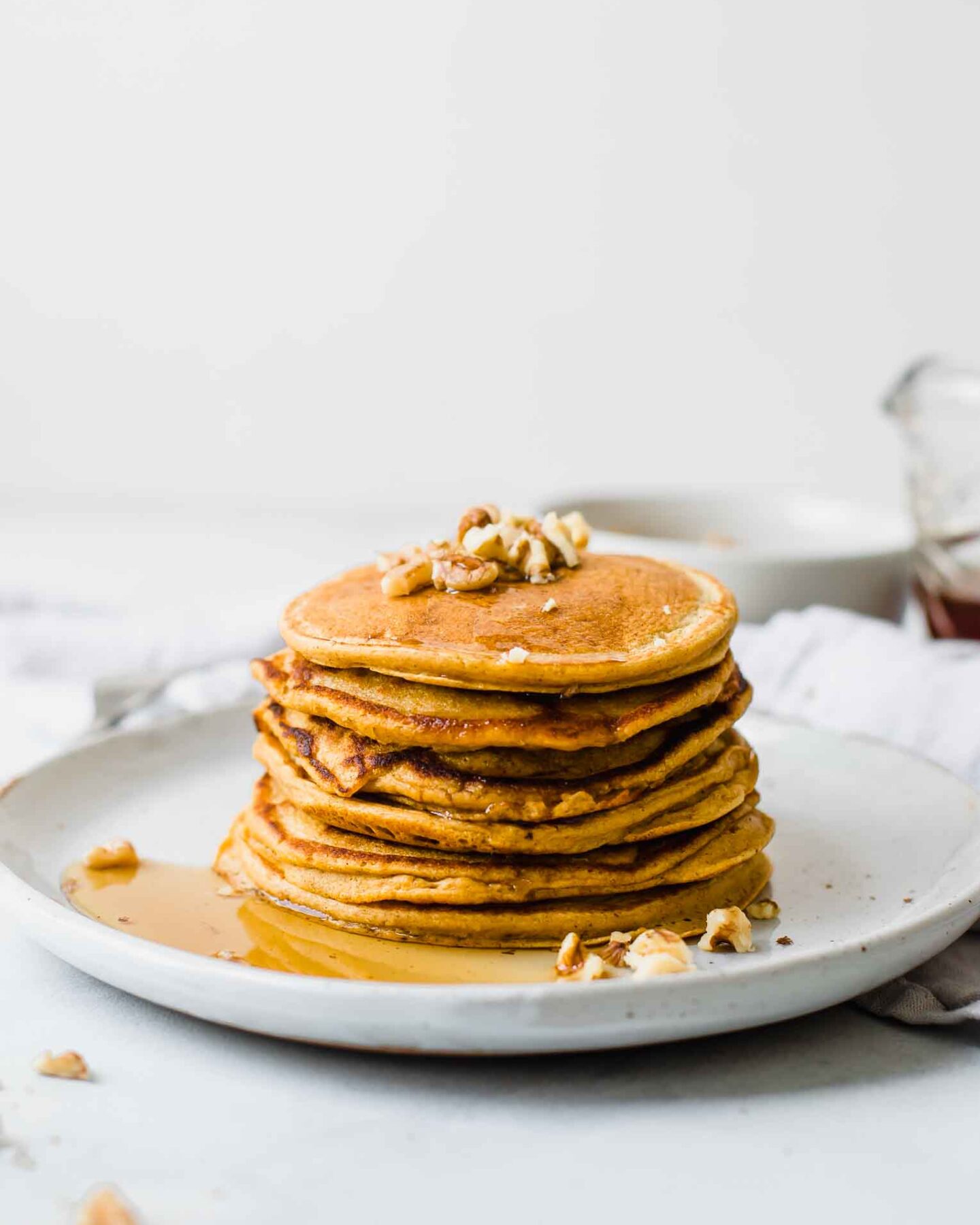 Stack of Healthy Sweet Potato Pancakes on a white plate.