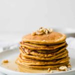 Close up shot of Healthy Sweet Potato Pancakes topped with walnuts.