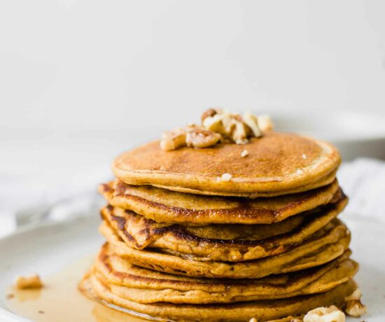 Close up shot of Healthy Sweet Potato Pancakes topped with walnuts.