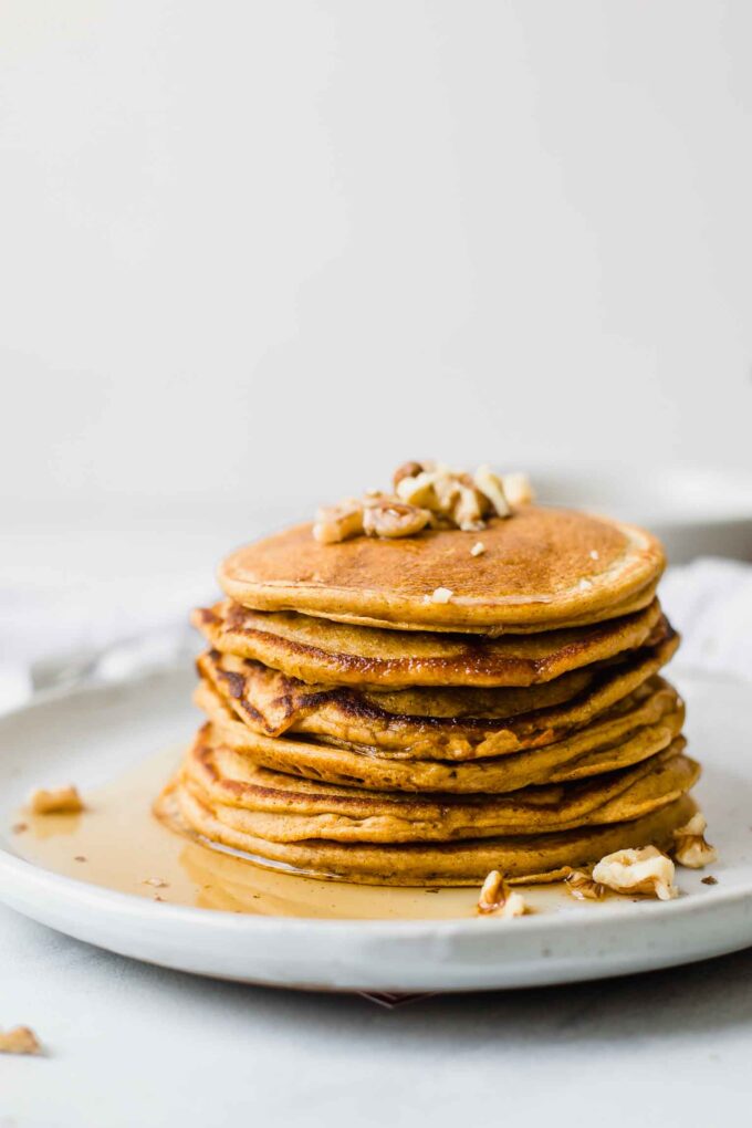 Close up shot of Healthy Sweet Potato Pancakes topped with walnuts.