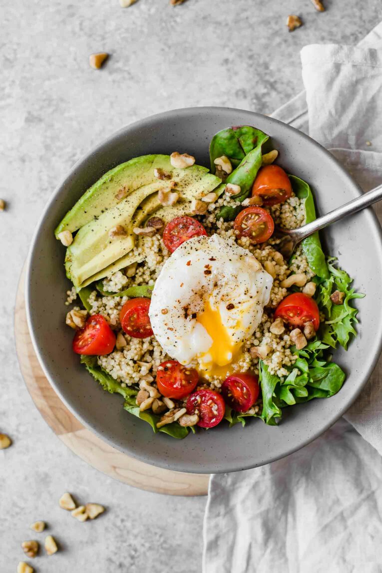 Top shot of Poached Egg & Avocado Breakfast Salad with runny egg.