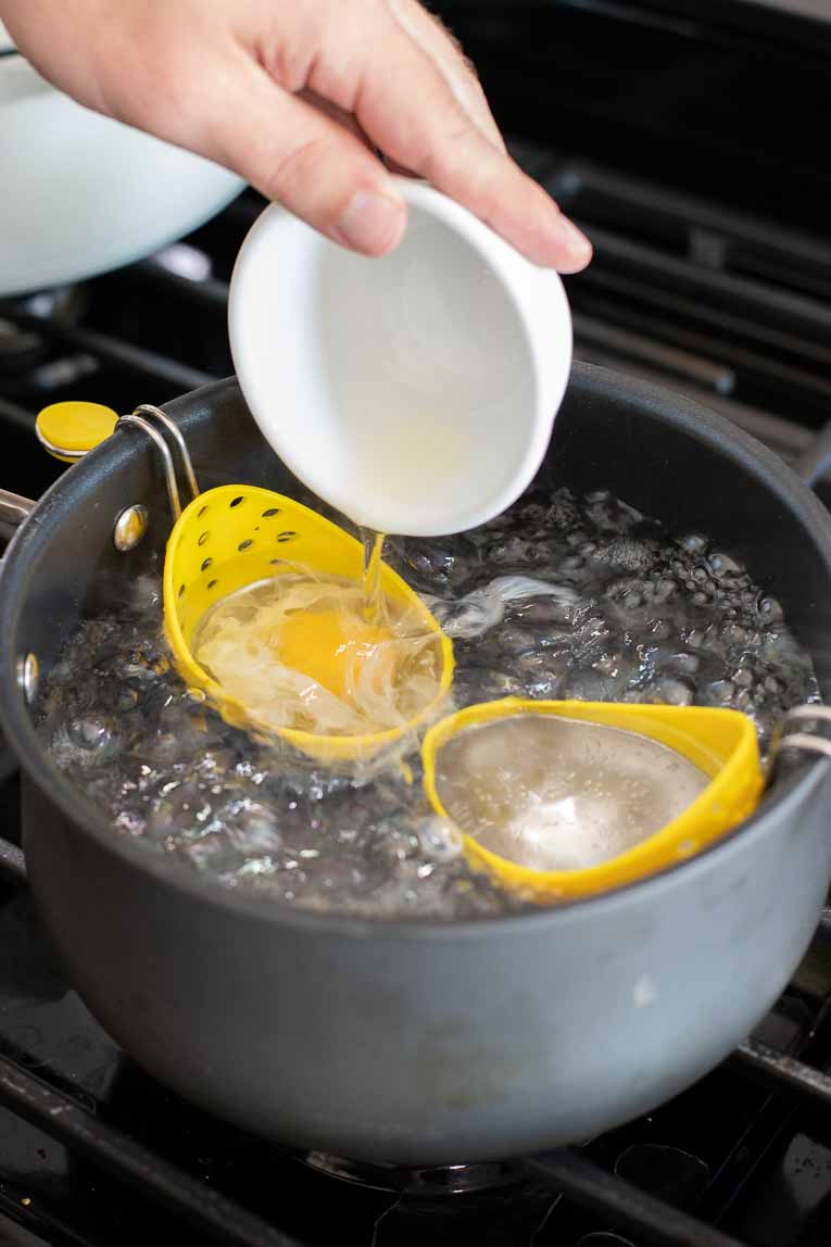 Eggs being poured into egg poachers.