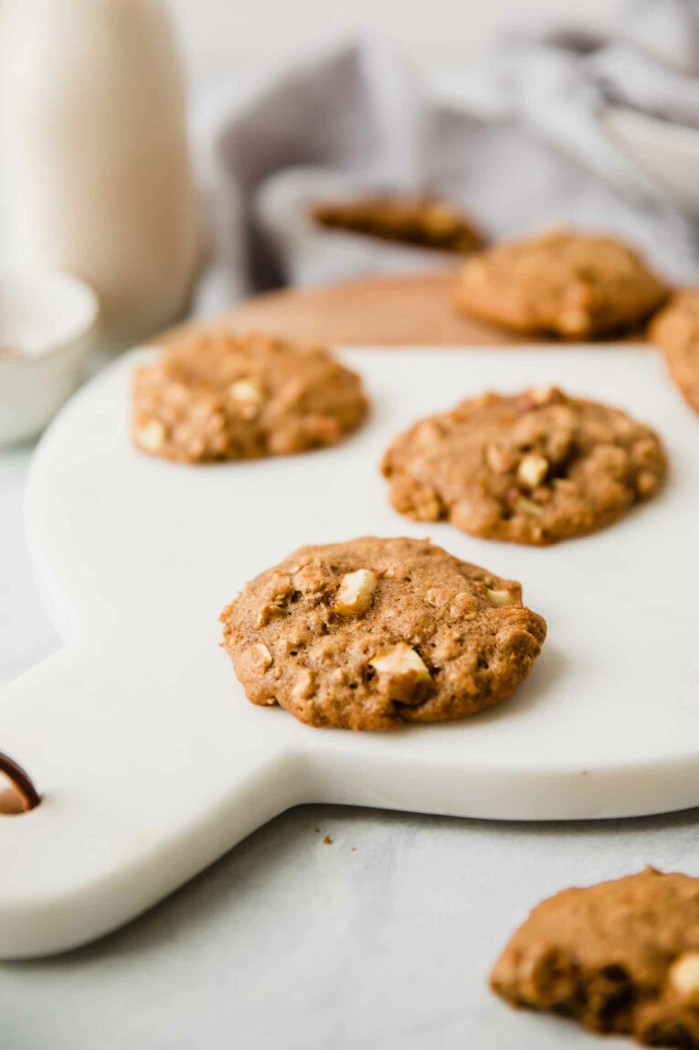 Close up of apple cinnamon oatmeal cookie on a cutting board.