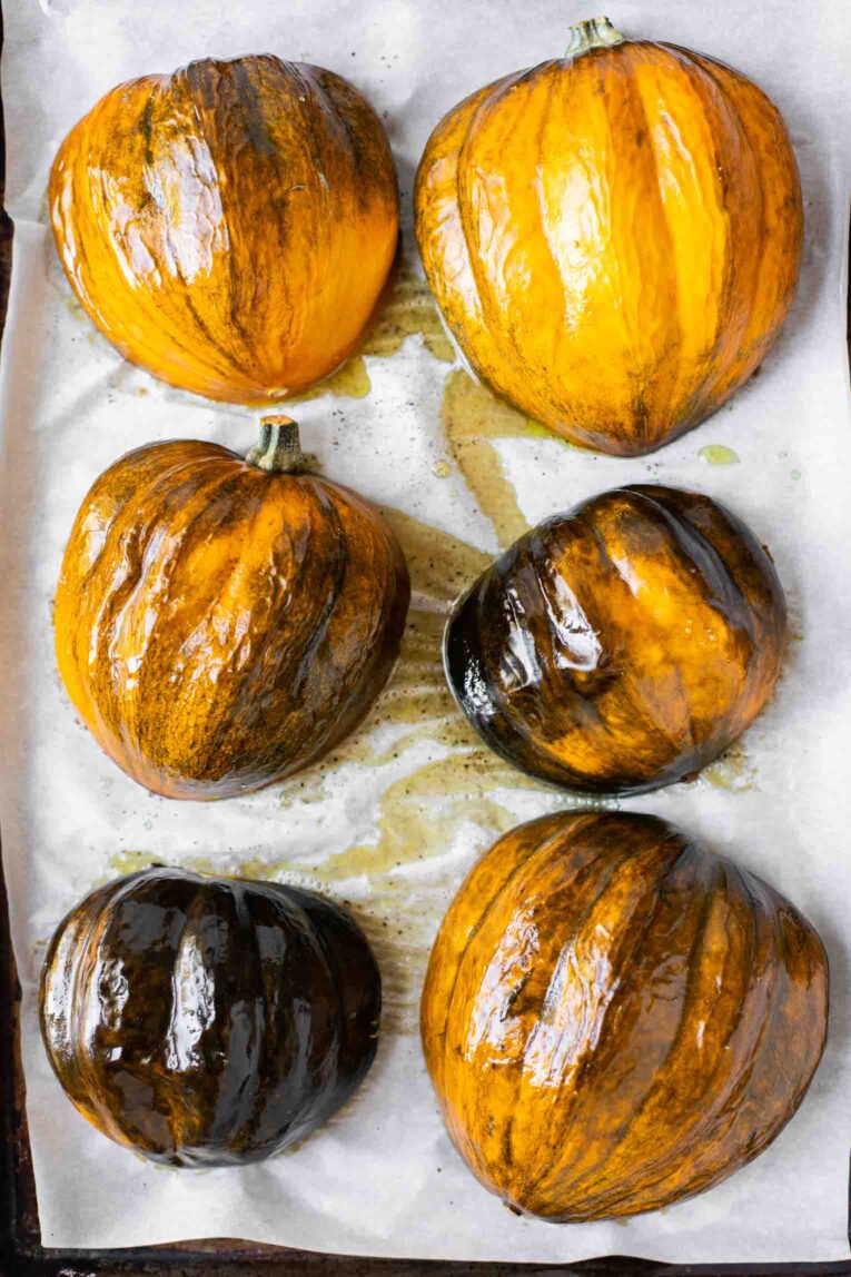 Roasted acorn squash on parchment paper.