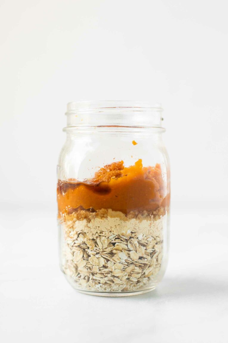 Pumpkin overnight oats ingredients in a mason jar.