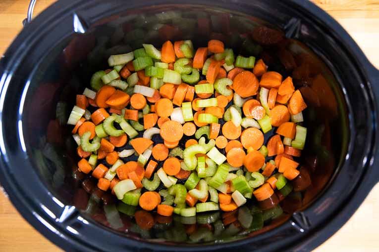 Carrots and celery in a slow cooker.