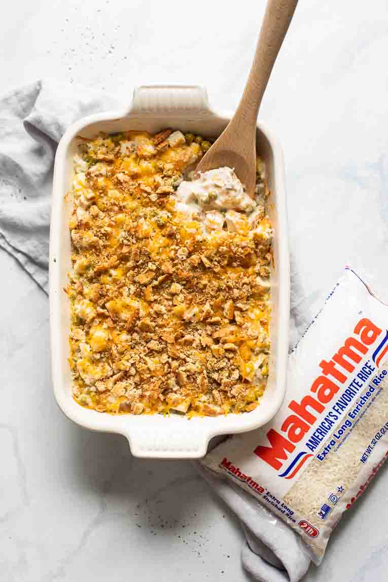 Turkey Rice Casserole with a wooden spoon next to bag of Mahatma Rice.