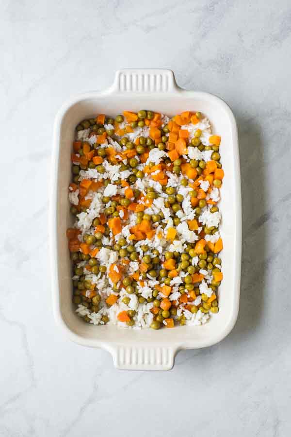Rice, peas, and carrots in a casserole dish.