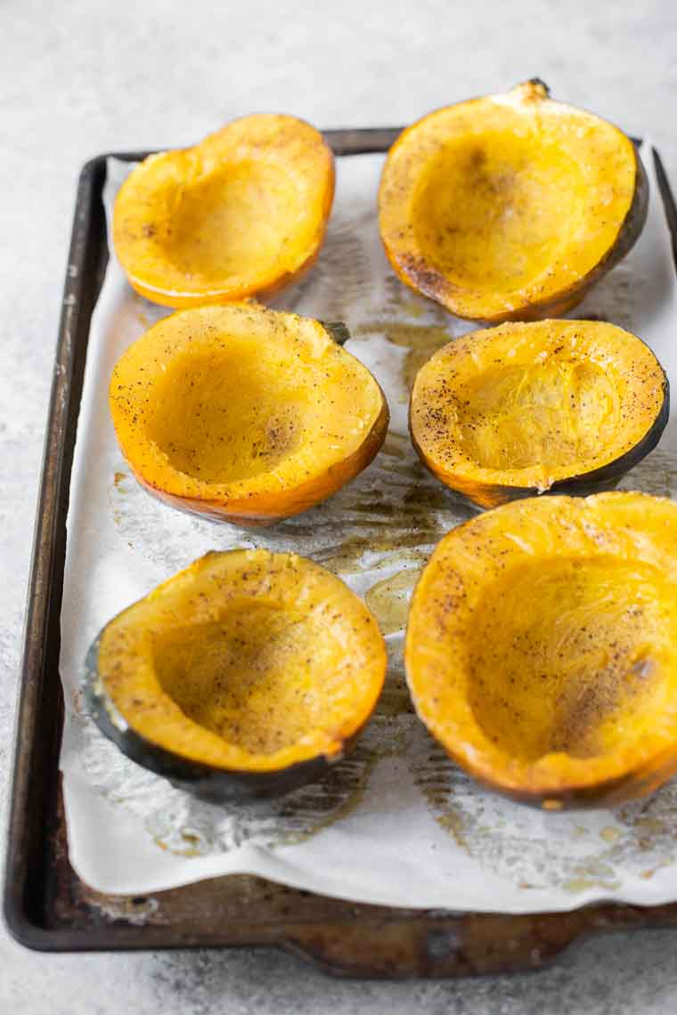Roasted acorn squash on a baking sheet.
