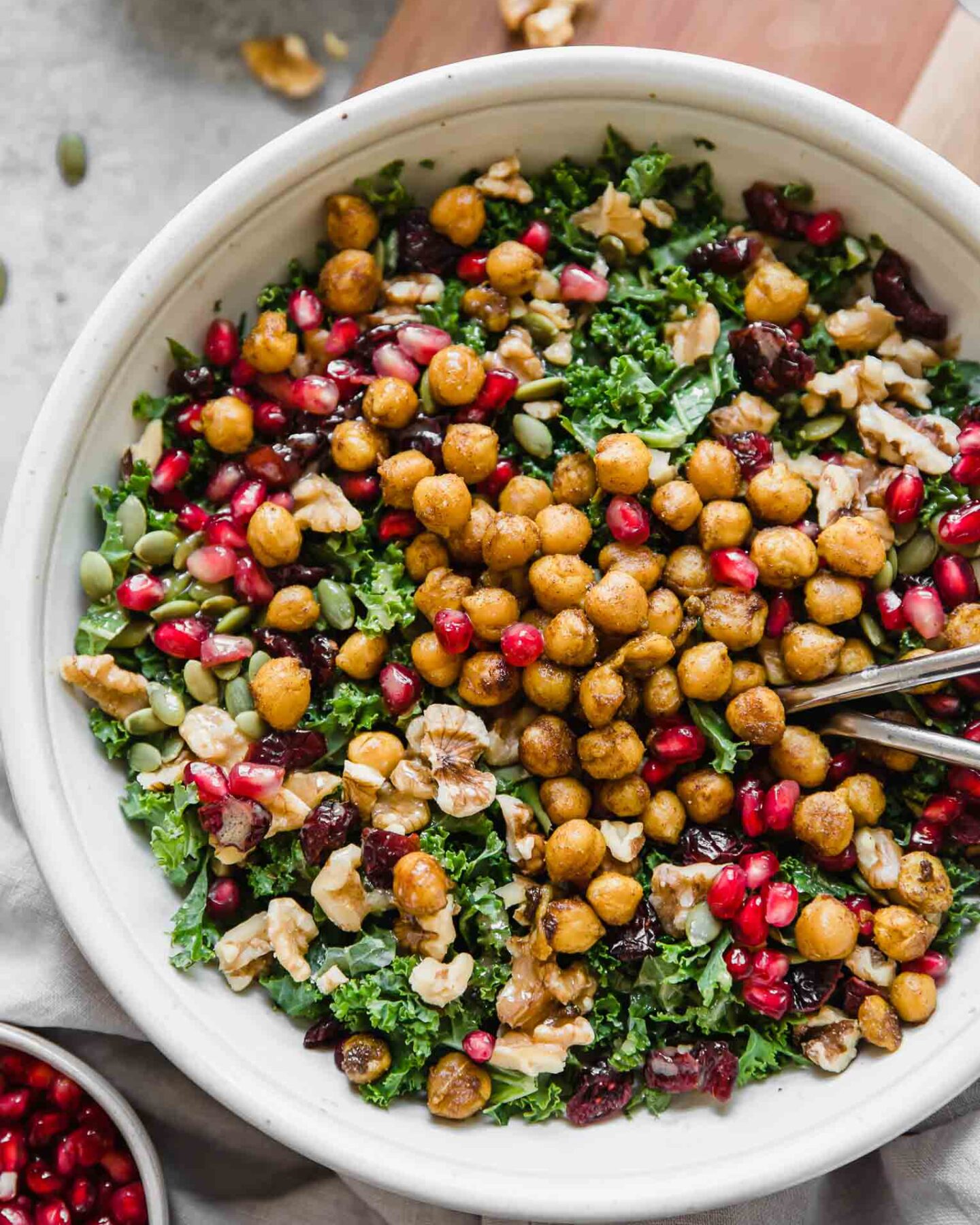Top shot of roasted chickpea fall salad in a grey bowl with forks.