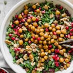 Top shot of roasted chickpea fall salad in a grey bowl with forks.