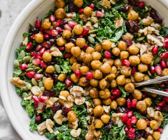 Top shot of roasted chickpea fall salad in a grey bowl with forks.