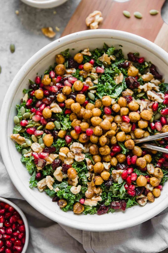 Top shot of roasted chickpea fall salad in a grey bowl with forks.