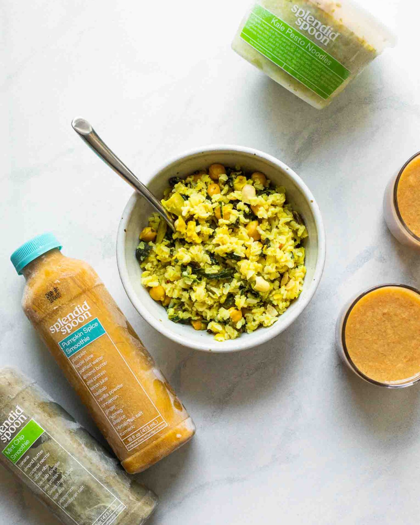 Bowl of curry rice next to Splendid Spoon smoothies.