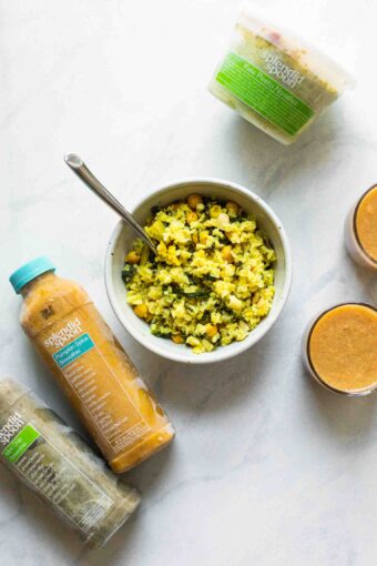 Bowl of curry rice next to Splendid Spoon smoothies.