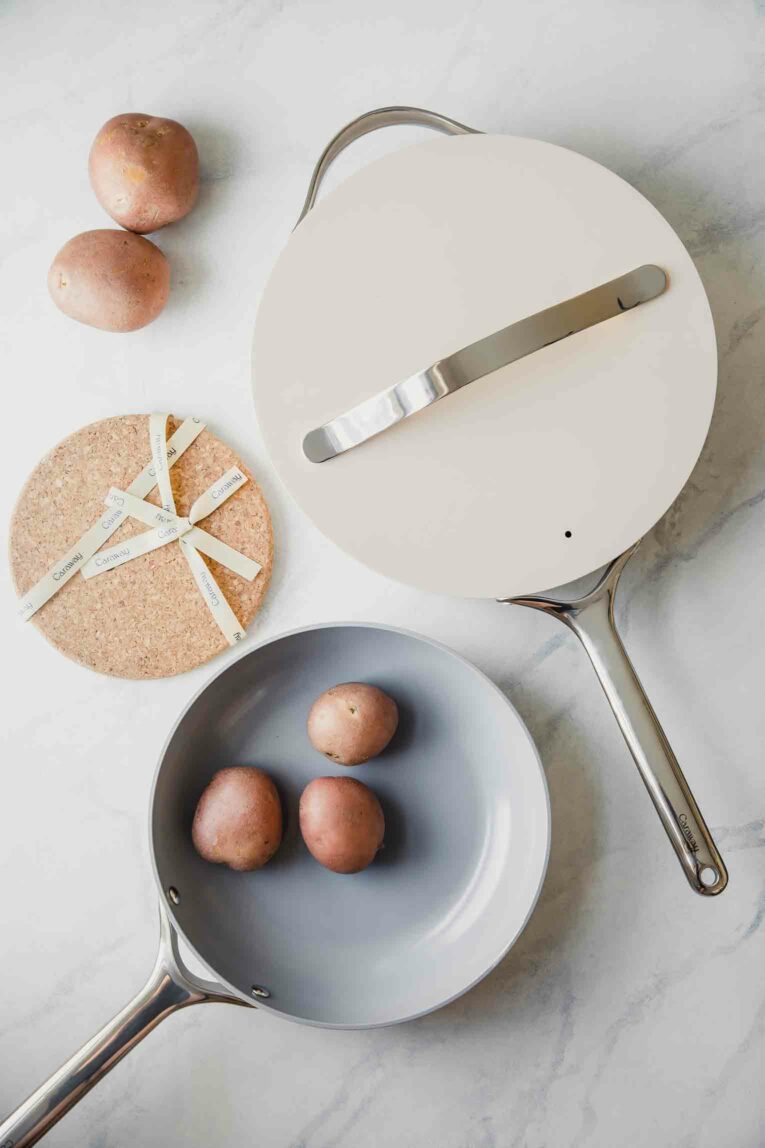 Caraway cookware set on a marble background.