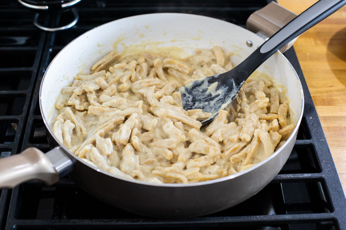 Creamy pasta in a sauce pan.