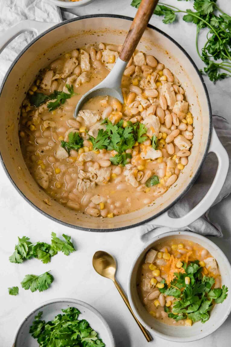 Styled top shot of creamy white chicken chili in a dutch oven.