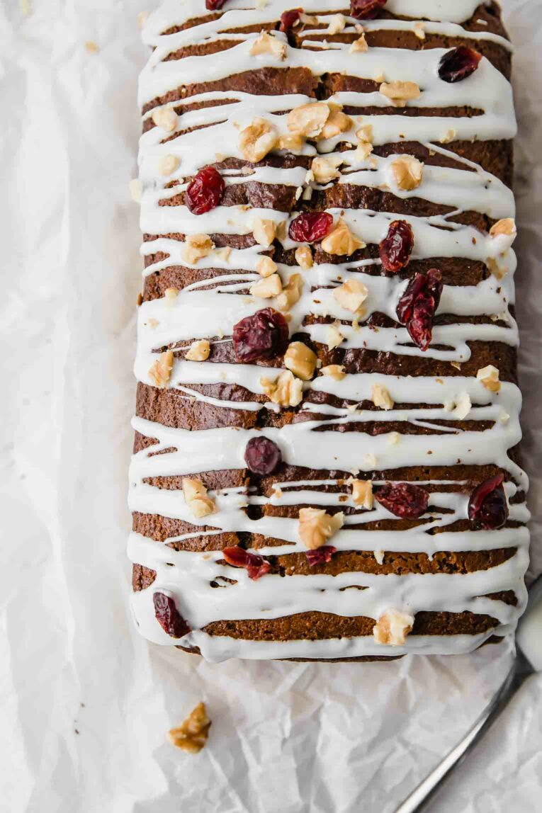 Top close up shot of gingerbread loaf drizzled with white chocolate.