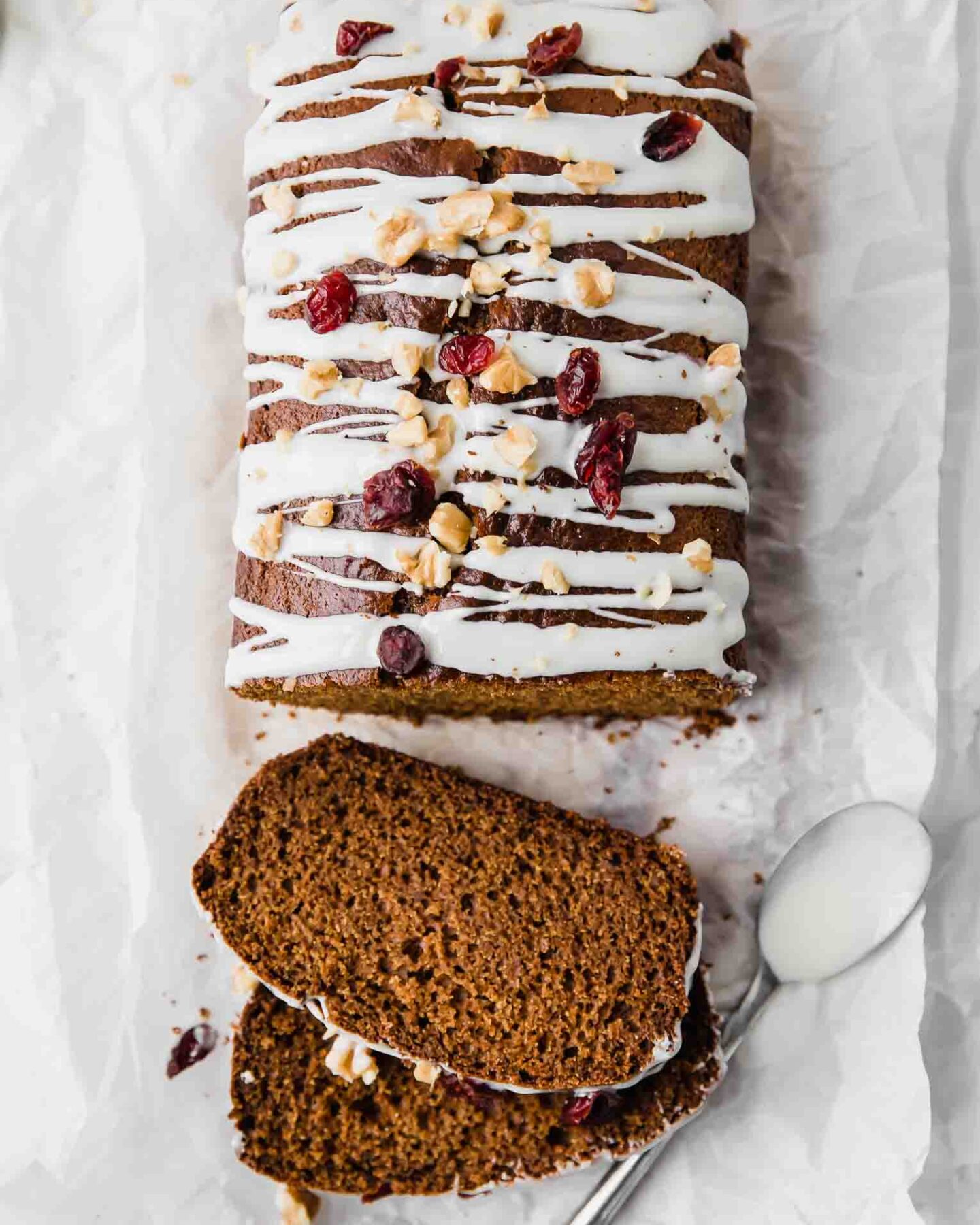 Top shot of healthy gingerbread loaf drizzled with white chocolate.