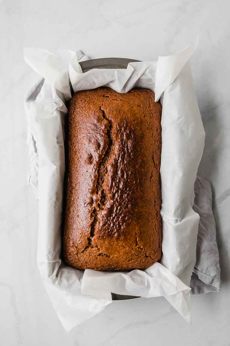 Baked gingerbread loaf in a loaf pan.