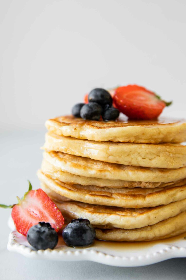 Close up shot of greek yogurt pancakes topped with fruit.