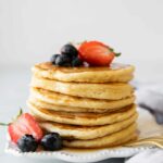 Yogurt pancakes stack topped with berries.