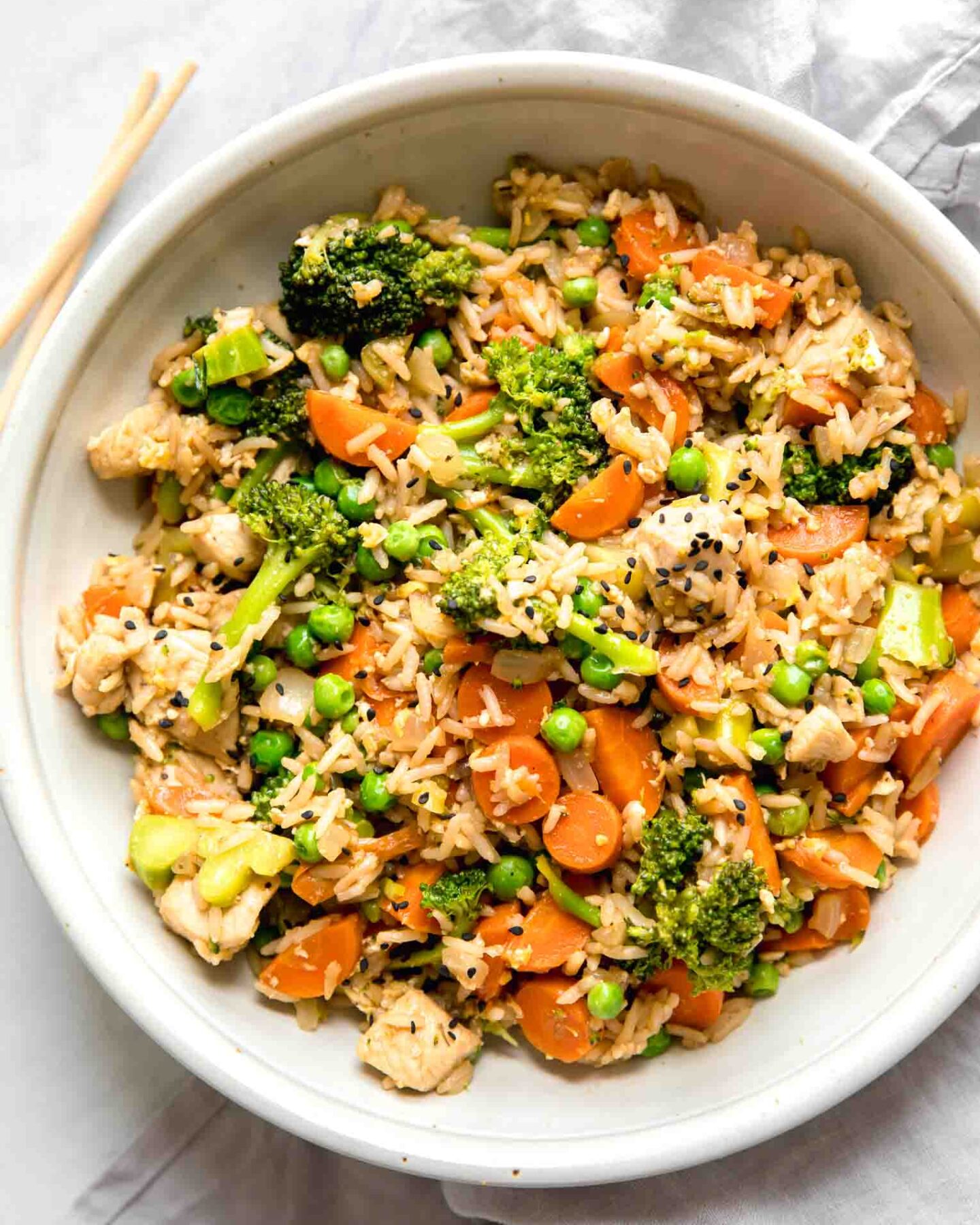 Top shot of Instant Pot Chicken Fried Rice recipe in a white bowl.