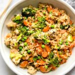 Top shot of Instant Pot Chicken Fried Rice recipe in a white bowl.