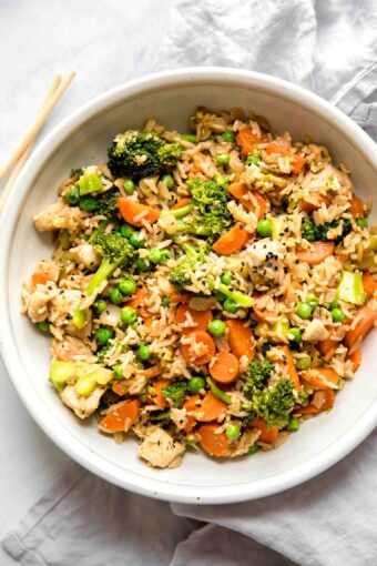 Top shot of Instant Pot Chicken Fried Rice recipe in a white bowl.