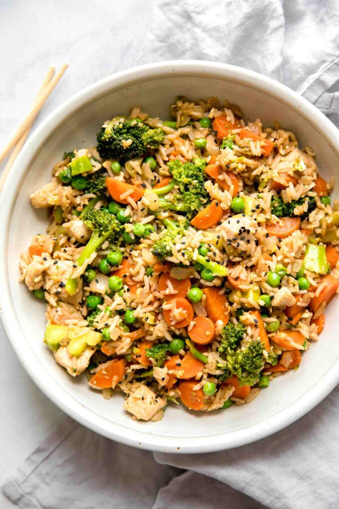 Top shot of Instant Pot Chicken Fried Rice recipe in a white bowl.