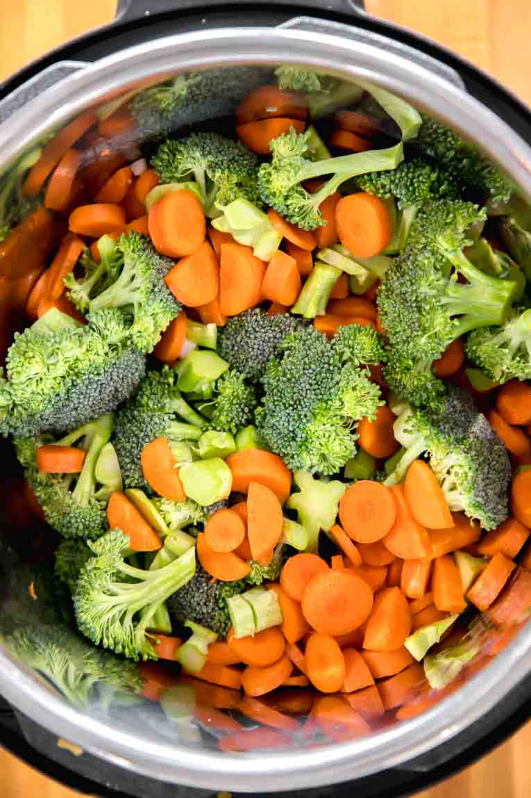 Broccoli and carrots being sautéed in an Instant Pot.