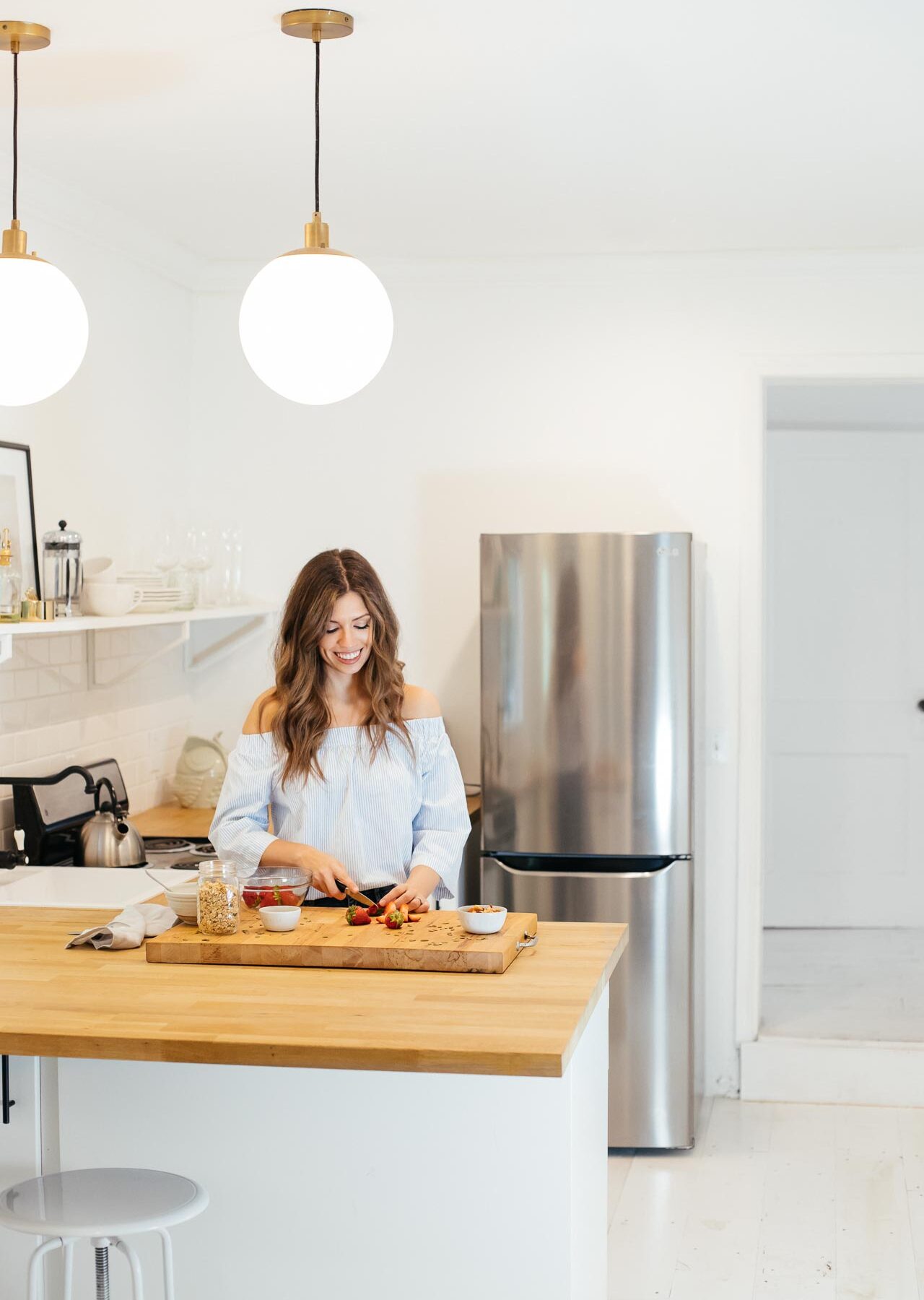 Woman cutting fruit in a healthy home kitchen.