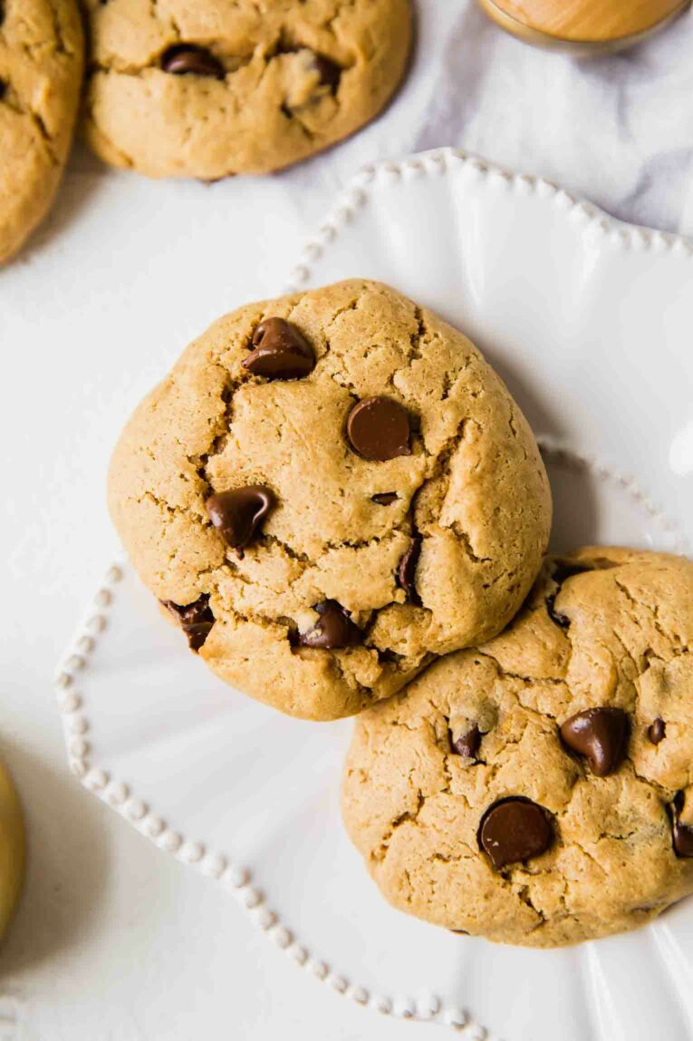 Two peanut butter chocolate protein cookies on a white plate.