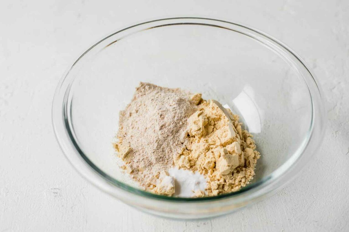 Dry ingredients for protein cookies being mixed in a bowl.